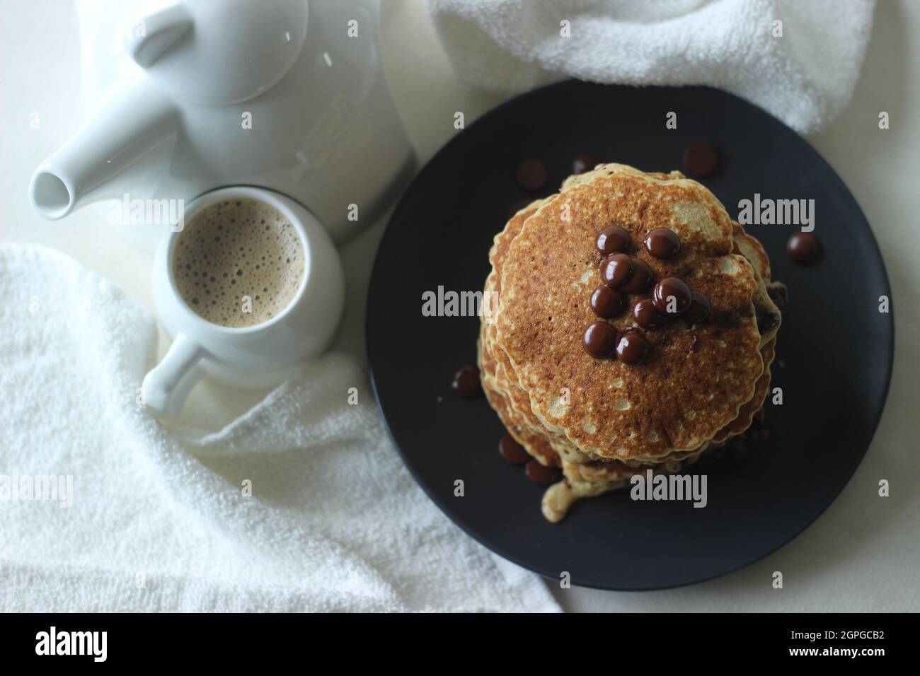 Stack of Oats Choco chips pancakes along with coffee for breakfast