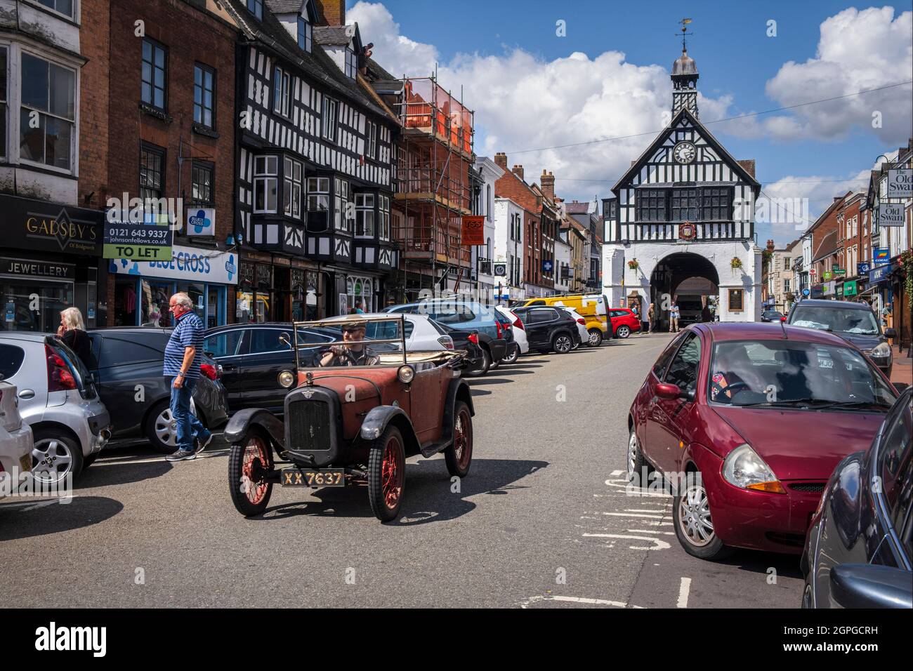 An Austin 7 being driven down the High Street in Bridgnorth, Shropshire Stock Photo