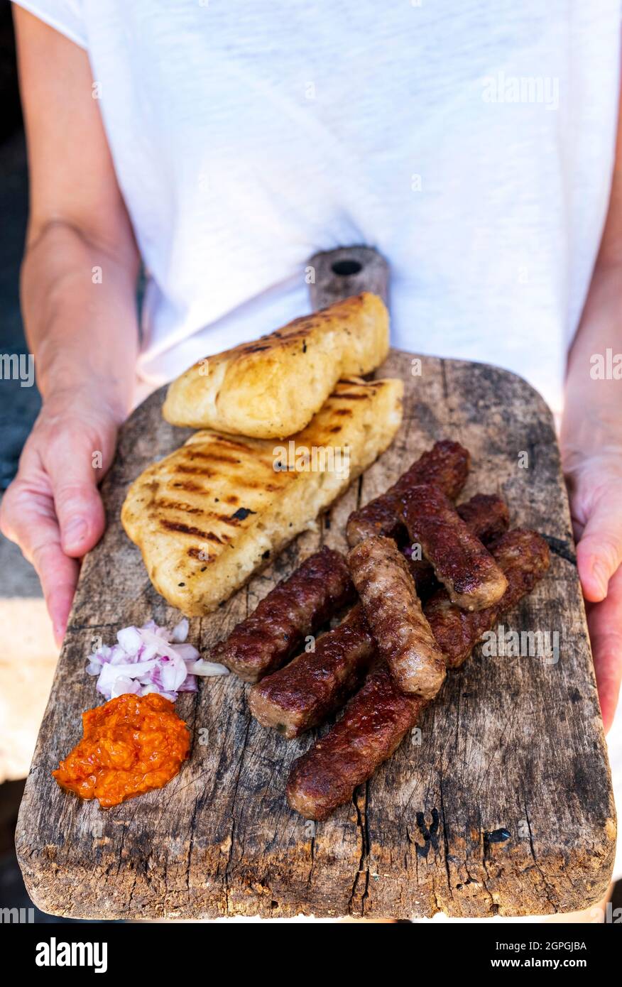 Croatia, Dalmatia, Elaphite Islands, Sipan Island, cevapi, traditional Balkan dish, minced beef and lamb sausages, mixed, hand formed, grilled, flat bread, chopped onions, minced red bell pepper Stock Photo