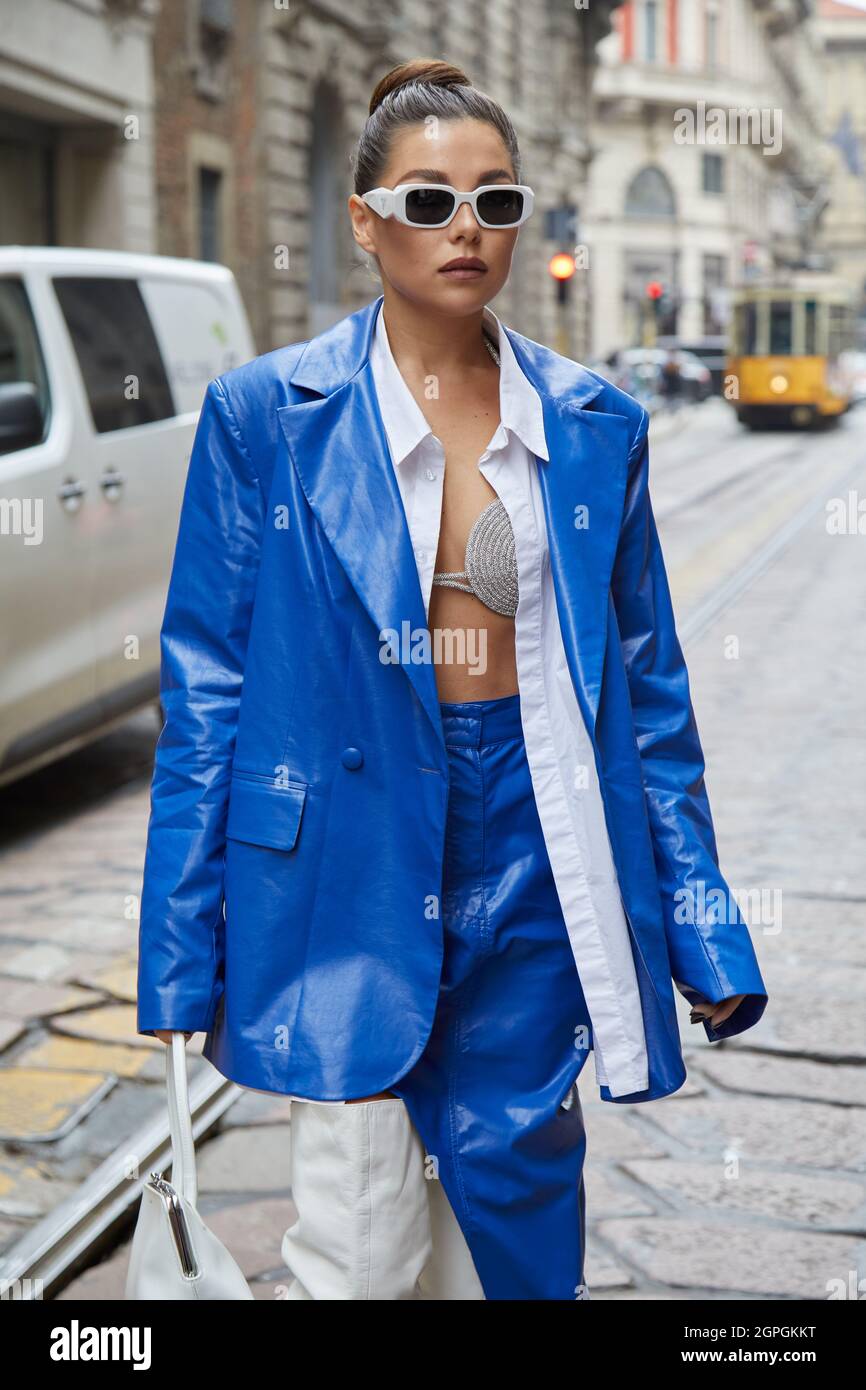 MILAN, ITALY - SEPTEMBER 25, 2021: Karina Nigay with electric blue leather jacket and skirt and white leather boots before Ermanno Scervino fashion sh Stock Photo