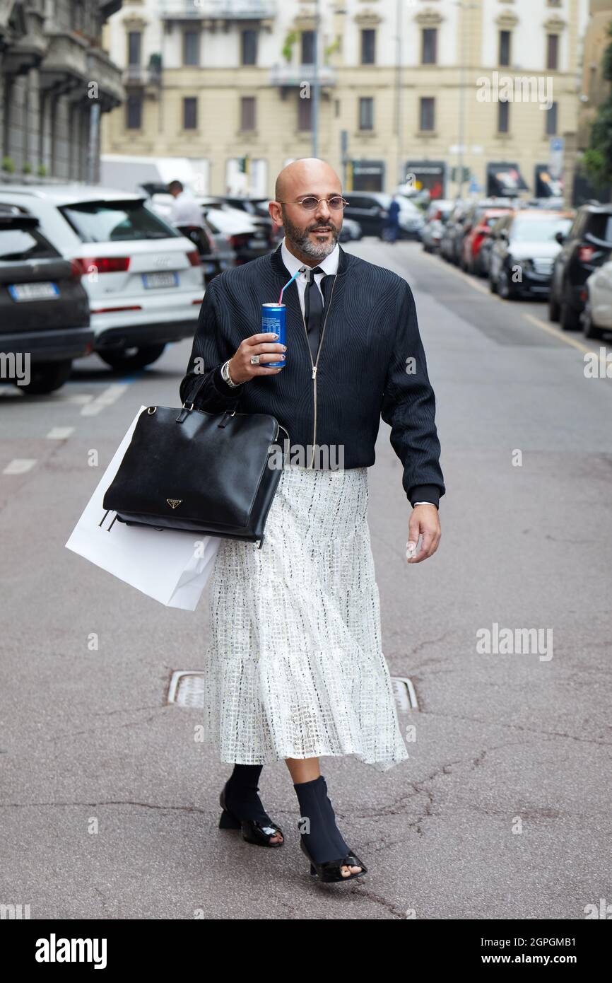 MILAN, ITALY - SEPTEMBER 25, 2021: Man with black bomber jacket and white  skirt before Salvatore Ferragamo fashion show, Milan Fashion Week street  sty Stock Photo - Alamy