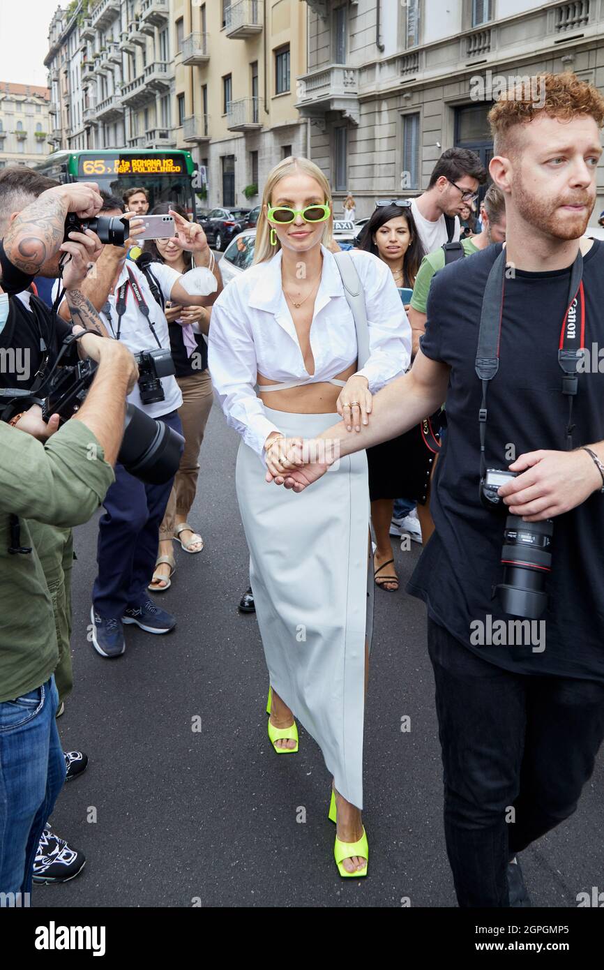 MILAN, ITALY - SEPTEMBER 25, 2021: Leonie Hanne with white shirt, skirt and fluorescent sunglasses and high heel shoes before Salvatore Ferragamo fash Stock Photo