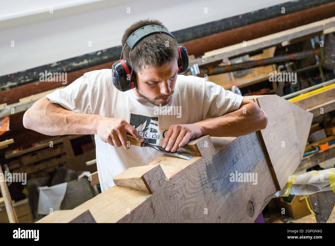 France, Finistere, Brest, Guip Shipyard, a marine carpenter works with a wood chisel Stock Photo