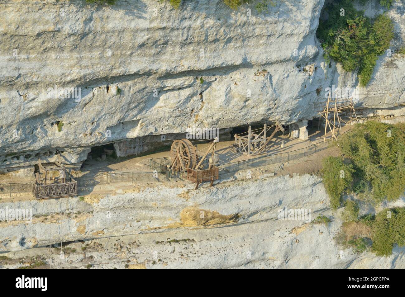 France, Dordogne, Perigord Noir, Vezere Valley, prehistoric site and decorated cave listed as World Heritage by UNESCO, Peyzac le Moustier, La Roque Saint Christophe Cliff, troglodytic site dating of the Prehistory, medieval stack machines reconstitution under the rock shelter (aerial view) Stock Photo