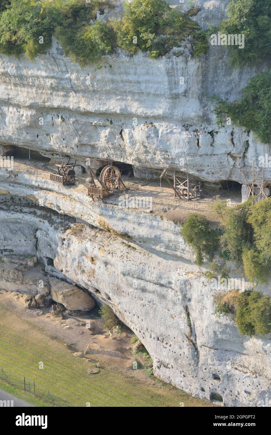 France, Dordogne, Perigord Noir, Vezere Valley, prehistoric site and decorated cave listed as World Heritage by UNESCO, Peyzac le Moustier, La Roque Saint Christophe Cliff, troglodytic site dating of the Prehistory, medieval stack machines reconstitution under the rock shelter (aerial view) Stock Photo