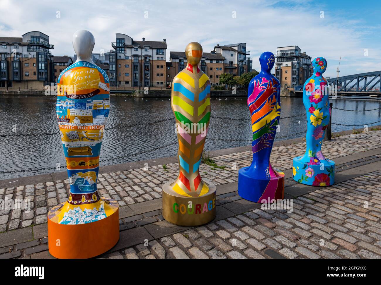 Colourful painted human figure sculptures from Gratitude exhibition,, Water of letih, Edinburgh, Scotland, UK Stock Photo