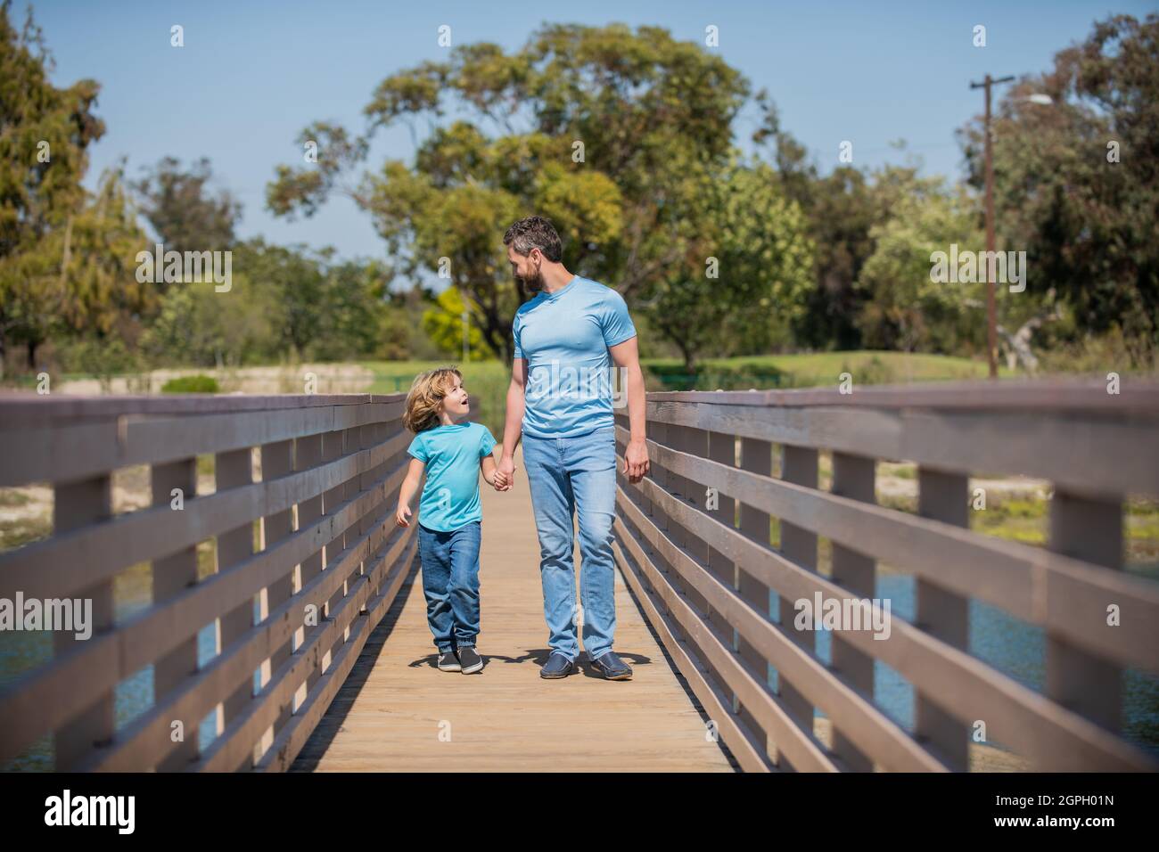 smiling father and son walking outdoor. family value. childhood and parenthood. Stock Photo