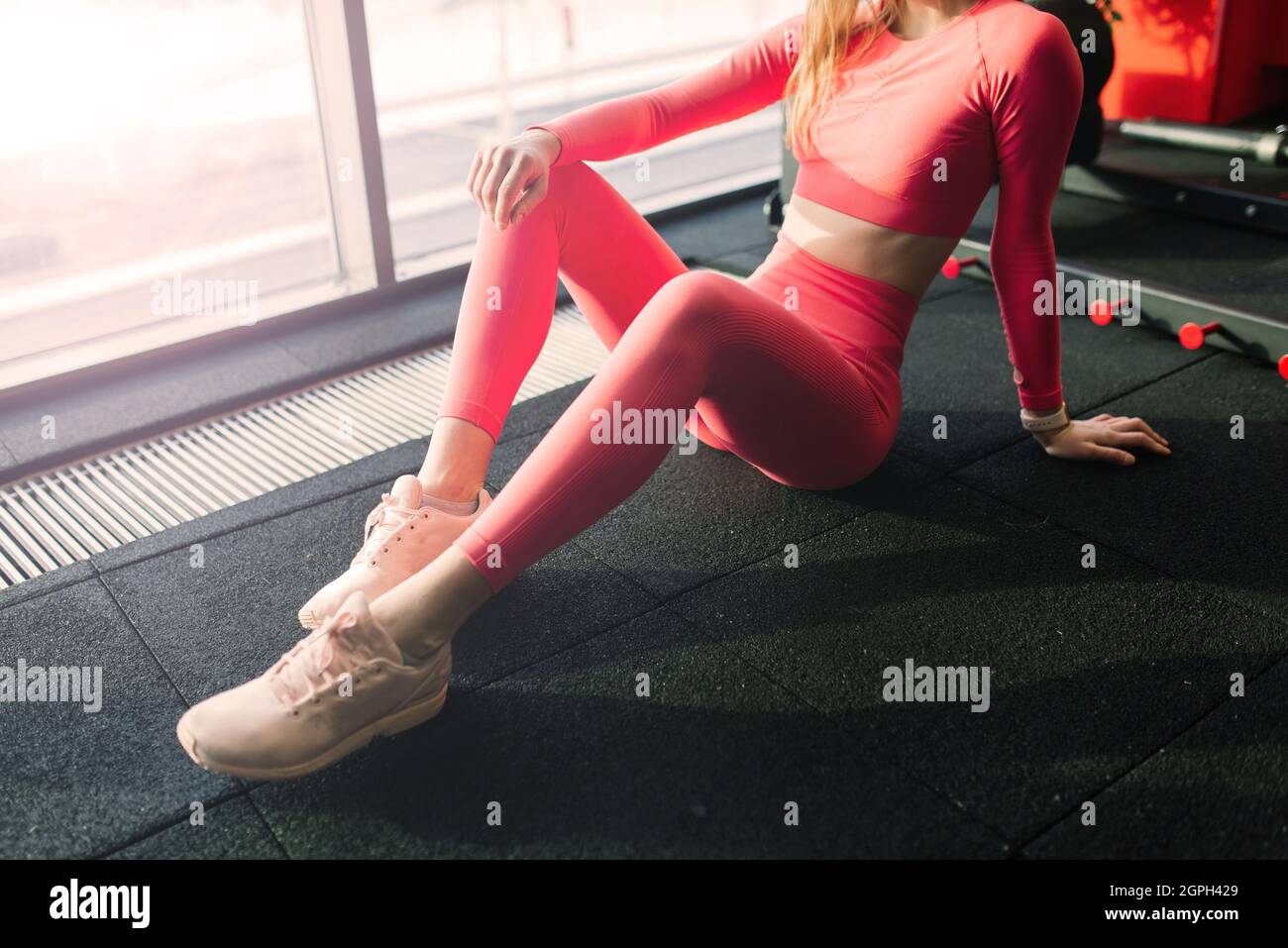 Young muscular woman doing core exercise on fitness mat in gym, doing ...