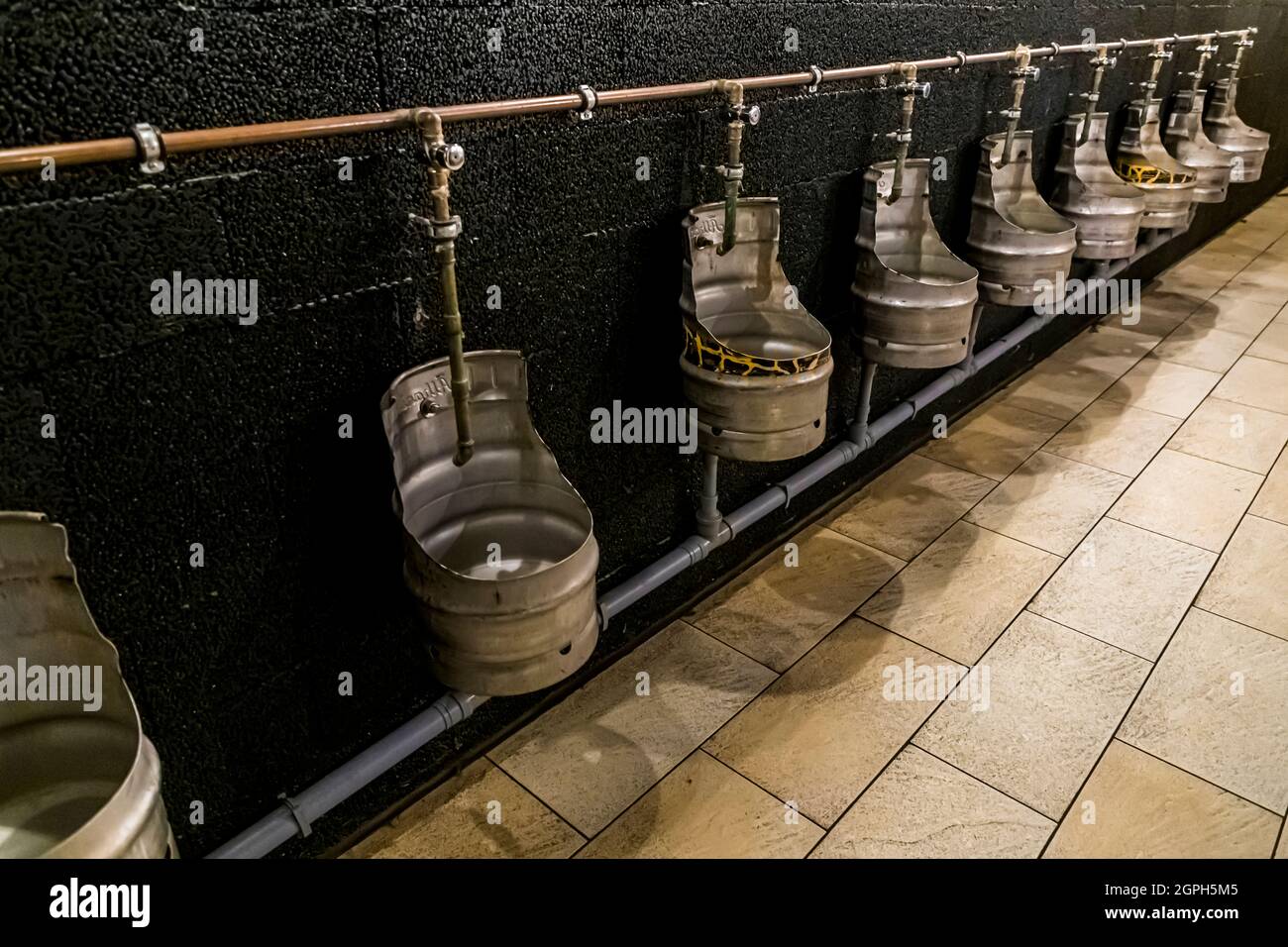Urinals made from cut open beer barrels in Storms Packhus, Odense