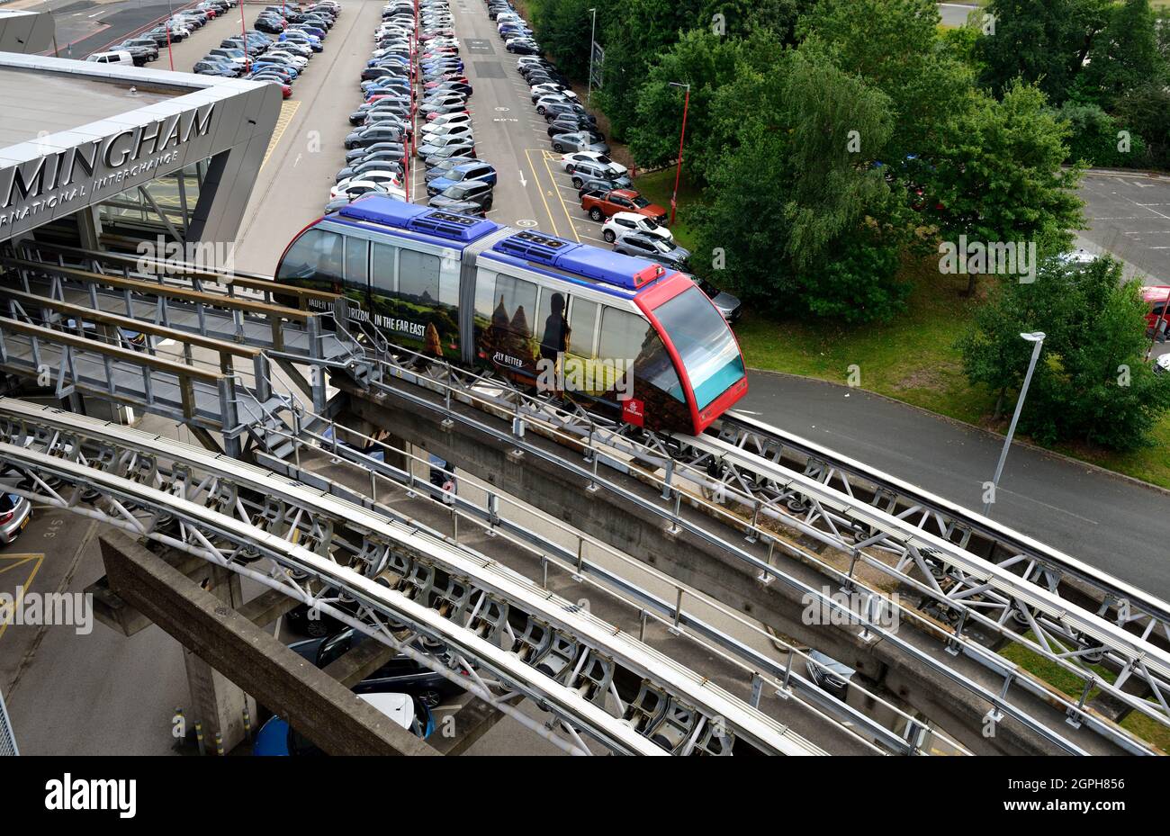 Birmingham International Train Station 'Air-Rail Link' system carriages leaving the train station on overhead tracks Stock Photo