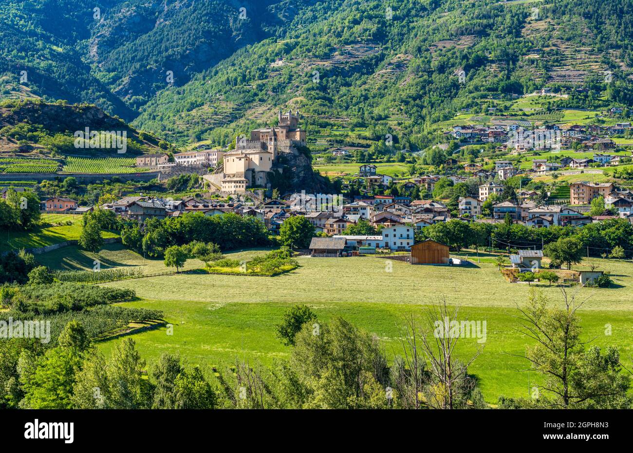 The village of Saint Pierre with its beautiful castle on a summer afternoon. Aosta Valley, northern Italy. Stock Photo