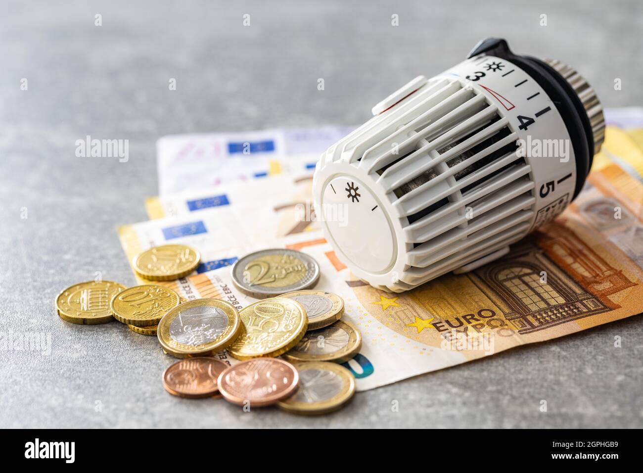 Thermostatic head and Euro money. Banknotes and coins. Stock Photo
