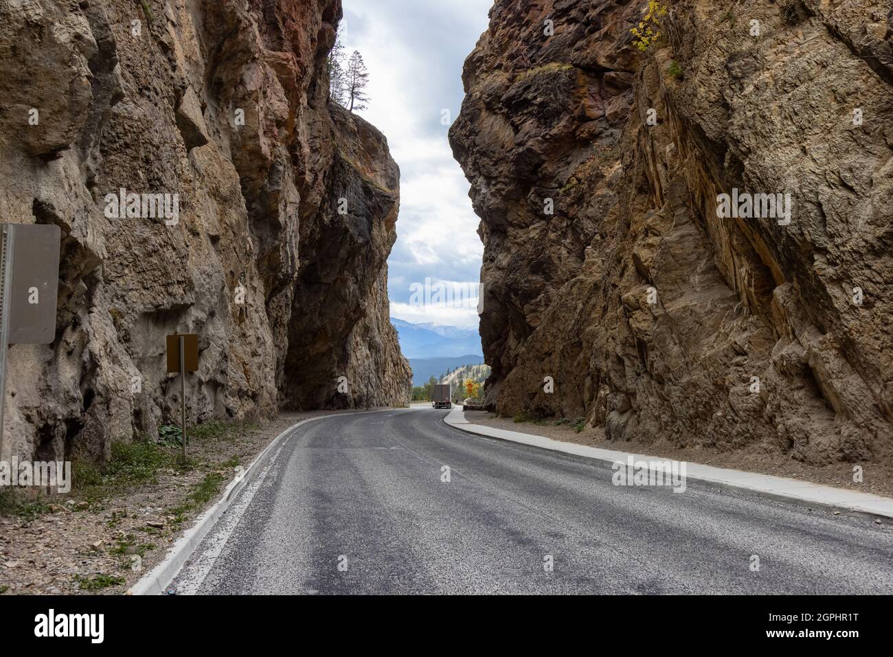 Scenic Road in the rocky canyon cliffs by Canadian Mountains. Stock Photo