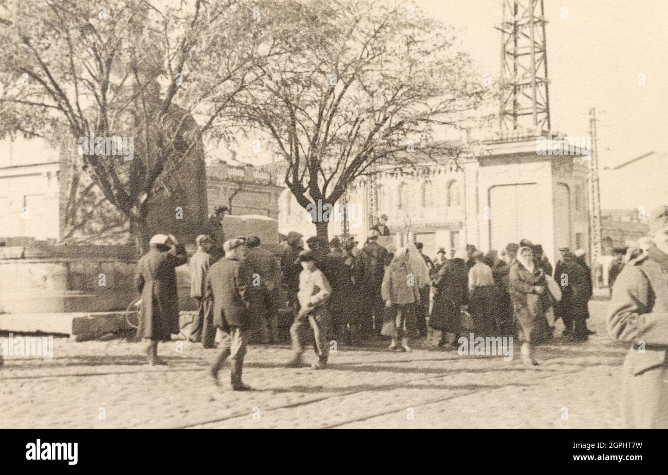 Crowd of people in the center of Simferopol (Crimea) where a partisan was hanged on tree during the Nazi occupation in Crimea in 1940s. Stock Photo
