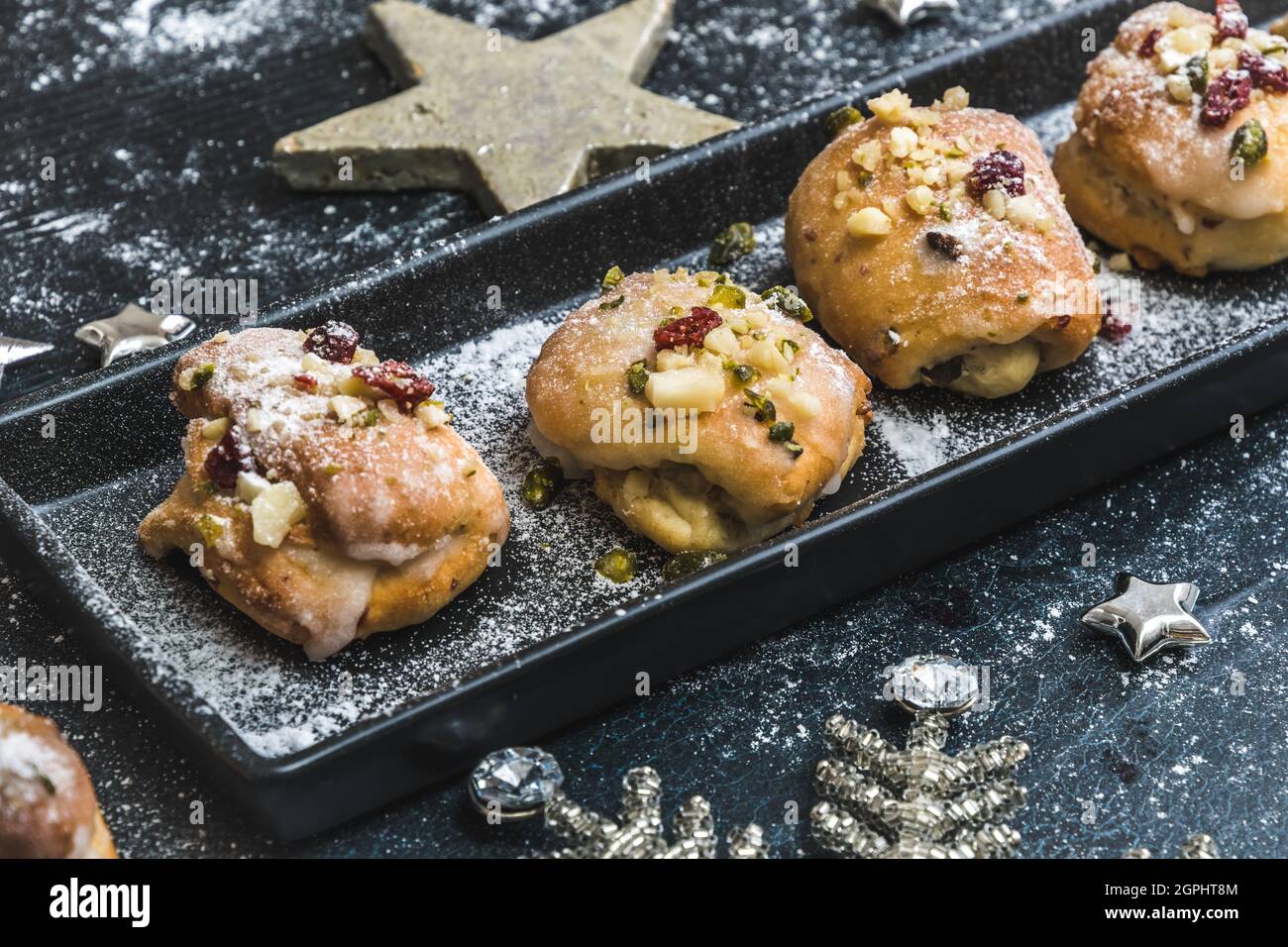 Mini Stollen Homemade mini stollen with icing, dried cranberries and pistachios on a ...