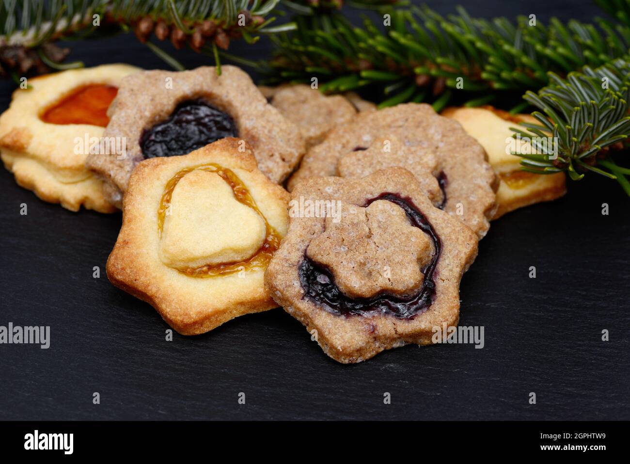 christmas cookies and fir lying on black shale at christmas time Stock Photo