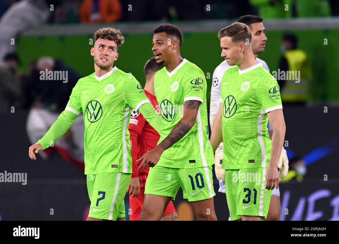 Wolfsburg, Germany. 29th Sep, 2021. Football: Champions League, VfL  Wolfsburg - FC Sevilla, Group Stage, Group G, Matchday 2 at Volkswagen  Arena. Wolfsburg's Gian-Luca Waldschmidt (l-r), Lukas Nmecha and Yannick  Gerhardt leave