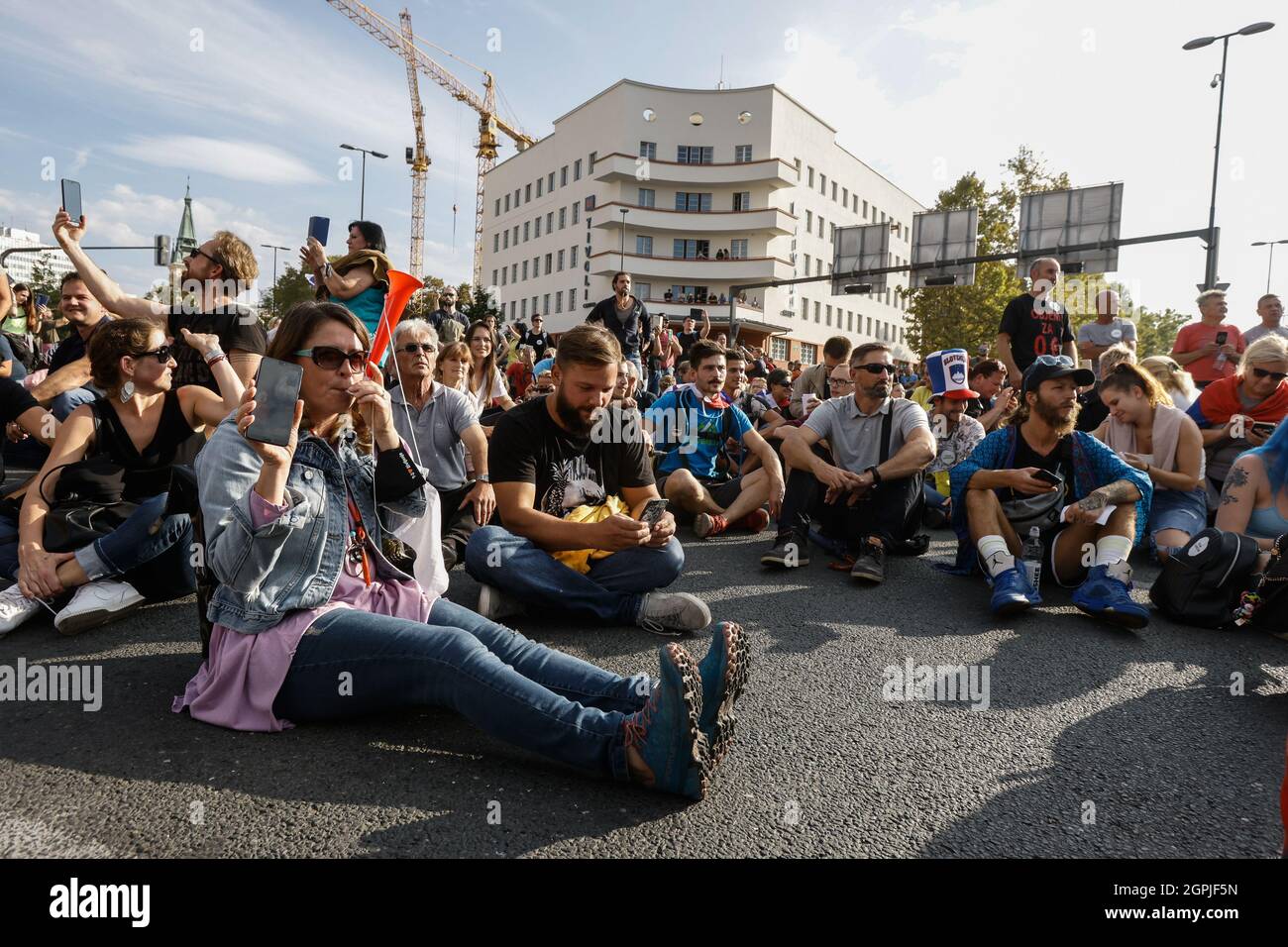 Ljubljana, Slovenia. 29th Sep, 2021. Protesters sit on the road as they block a busy intersection in Ljubljana during the demonstration.Thousands of people protested against the government, covid measures, wearing of face masks, vaccines and RVT green pass (Recovered-Vaccinated-Tested) condition in Ljubljana, Slovenia. (Photo by Luka Dakskobler/SOPA Images/Sipa USA) Credit: Sipa USA/Alamy Live News Stock Photo