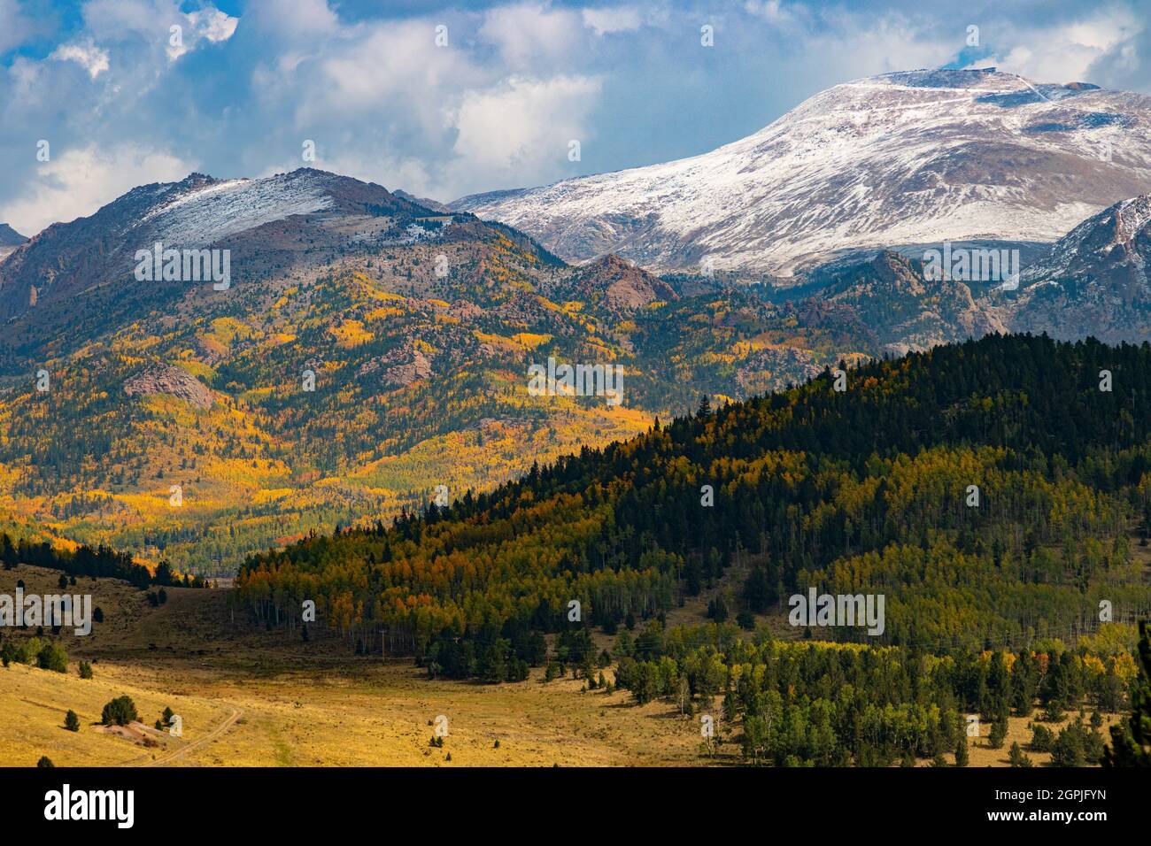 Fresh snow puts a mantle of white on the blazing colors of autumn on Pikes Peak Colorado Stock Photo