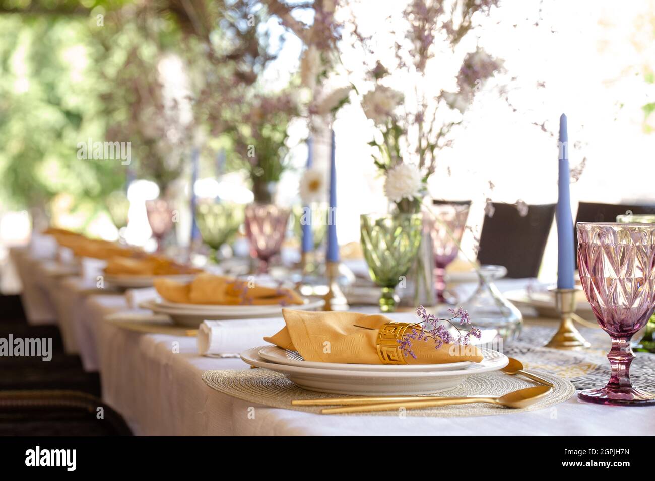 decorative table setting with beautiful dishes and flowers. Stock Photo