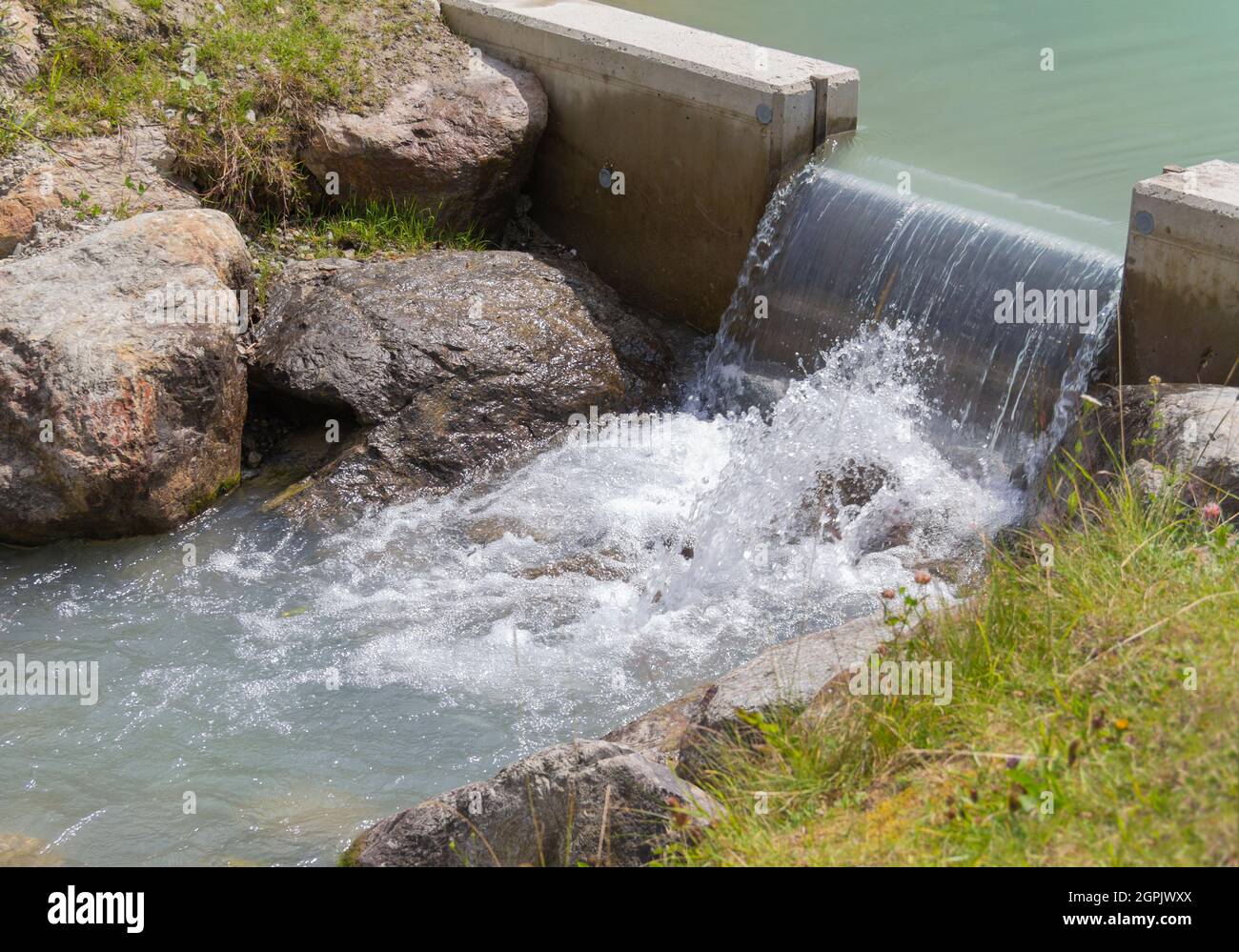 Open watergate with flowing water in sunny ambiance Stock Photo