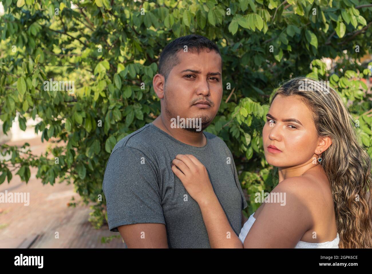 Young Hispanic Couple Looking in Camera Stock Photo