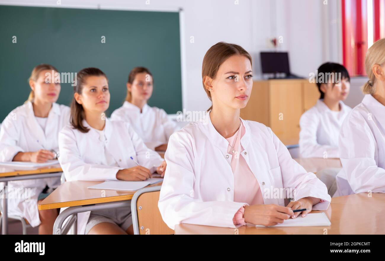 Medical students writing in notepads Stock Photo