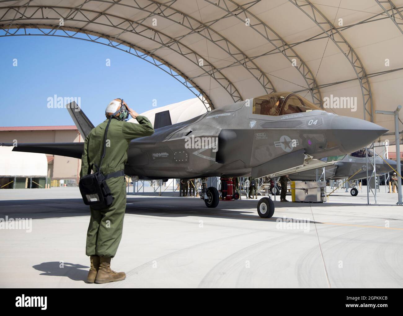 A U.S. Marine with Marine Fighter Attack Squadron (VMFA) 225 salutes Lt. Col. Alexander Goodno, commanding officer of VMFA 225, before takeoff at Marine Corps Air Station Yuma, Ariz., September 25, 2021. VMFA-225 participated in their first flight as an F-35B squadron. This marked the end of the first phase in the transition from a legacy F/A-18D Hornet squadron to an F-35B squadron. (U.S. Marine Corps Photo by Lance Cpl. Matthew Romonoyske-Bean) Stock Photo
