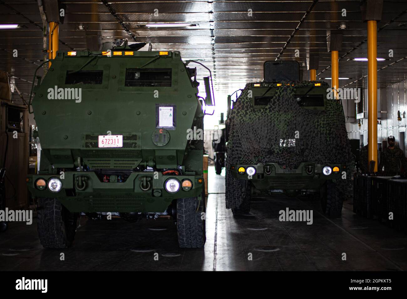 U.S. Marine Corps High Mobility Artillery Rocket Systems with 3d Battalion, 12th Marines embark the USNS Brunswick during Exercise Noble Jaguar 2021 at Naha Port, Okinawa, Japan, Sept. 28, 2021. The Marine Corps and Navy leveraged integrated command and control and joint sensors to expand battlefield awareness, share targeting data, and conduct long-range precision strikes in support of sea control and sea denial in contested maritime environments. III Marine Expeditionary Force executed these actions as a part of an integrated operation with 7th Fleet to maintain readiness and demonstrate U.S Stock Photo