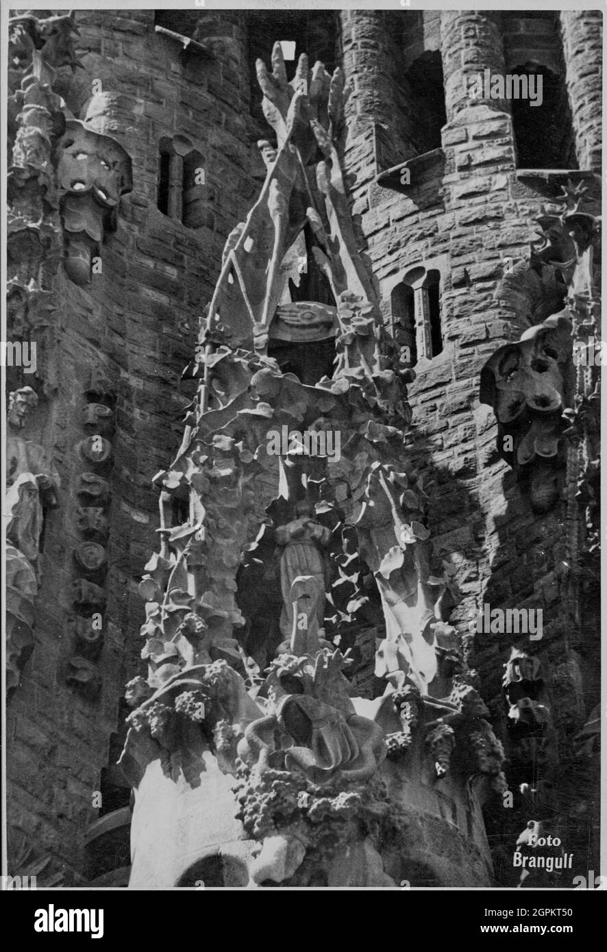 Sagrada Familia (Nativity Facade): portico of the Faith with the Immaculate Conception that is inside a crucible of three pipes that represent the Holy Trinity and on the summit there is the hand with the eye that sees everything as a symbol of Divine Providence, 1934. Author: JOAN MATAMALA FLOTATS. Stock Photo