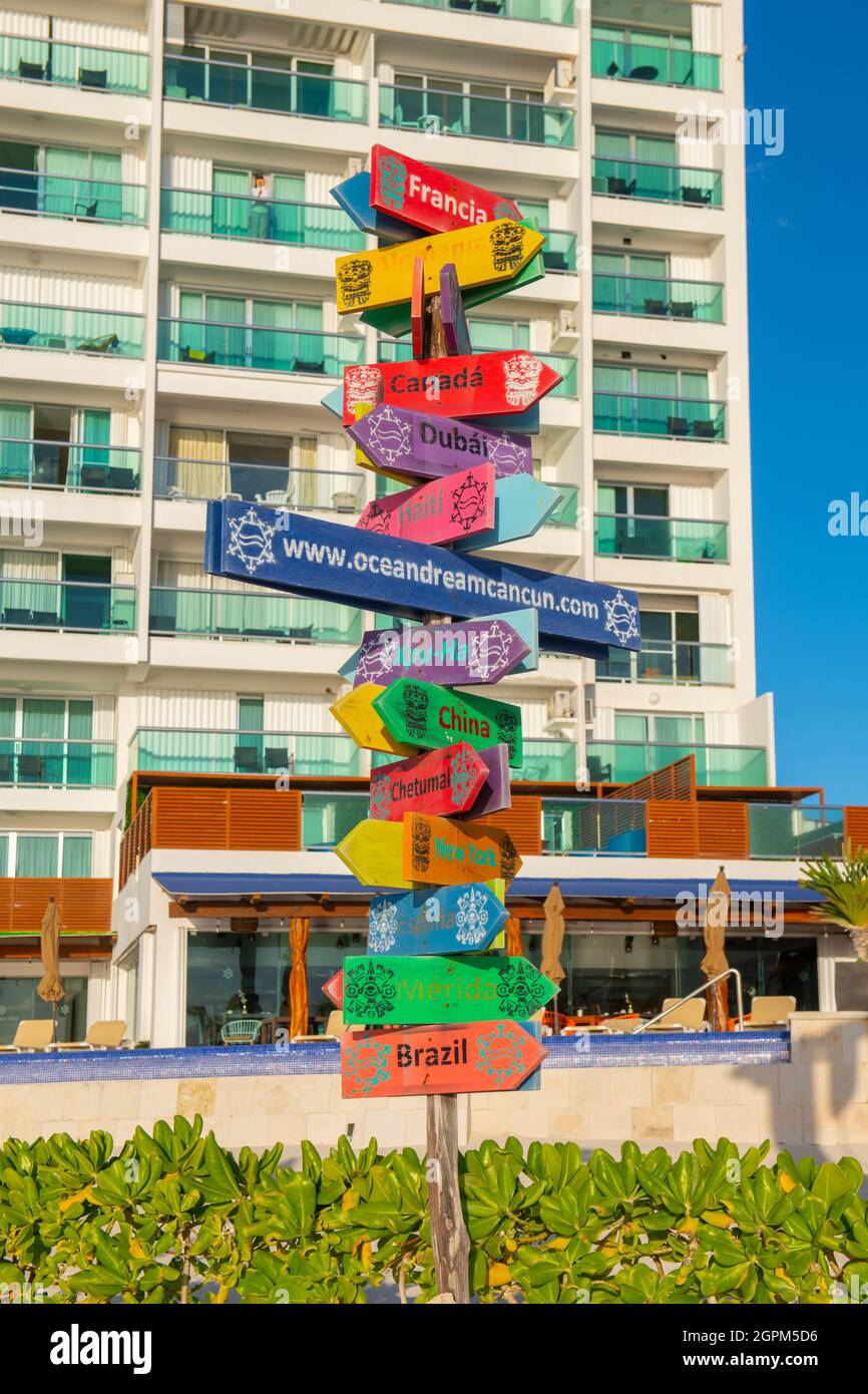 Road sign with country names in different directions on Chacmool Beach, Cancun, Quintana Roo QR, Mexico. Stock Photo