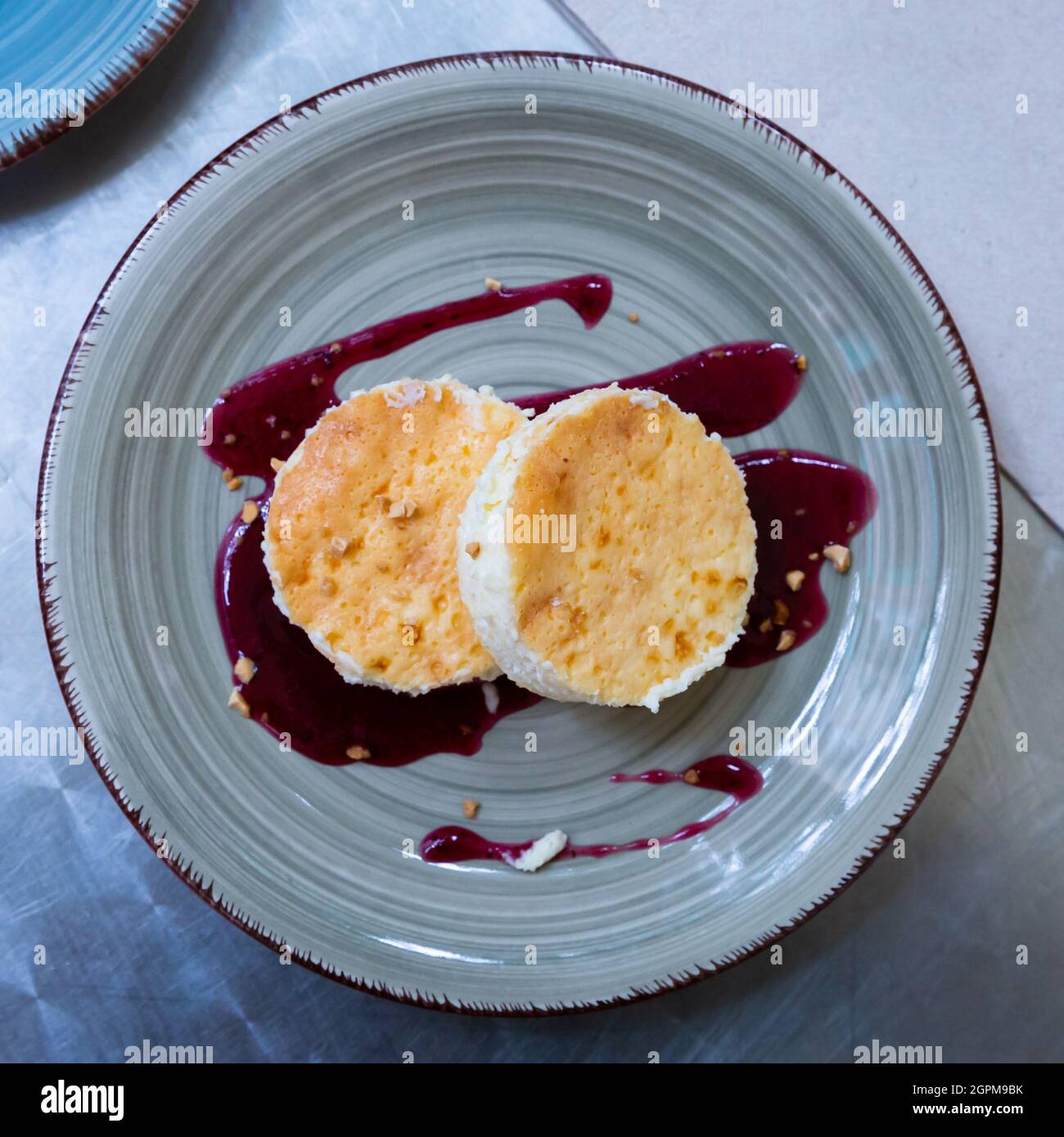 Classic cheesecake served with sweet berry sauce Stock Photo Alamy