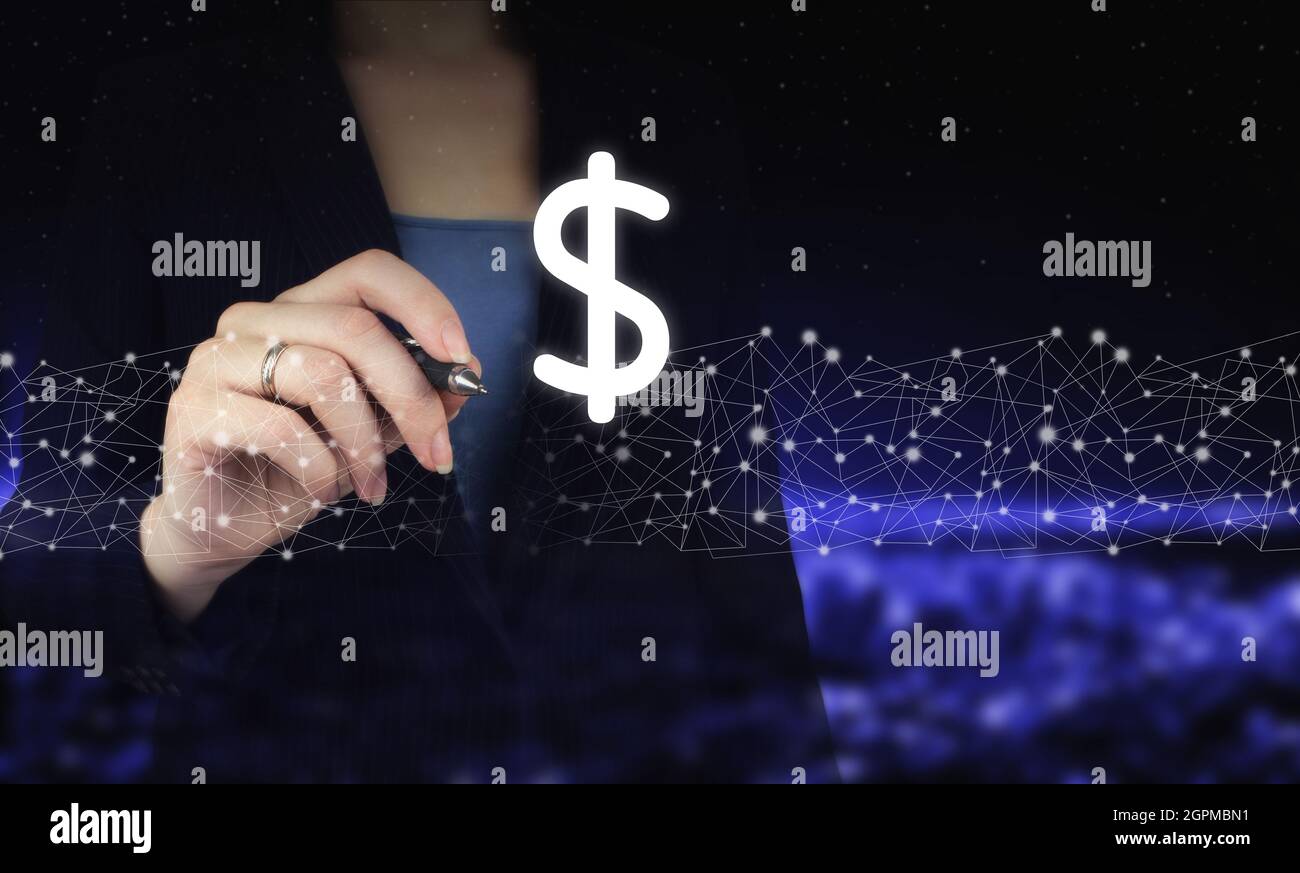 Concept of insurance or bank, currency growth. Hand holding digital graphic pen and drawing digital hologram dollar sign on city dark blurred backgrou Stock Photo