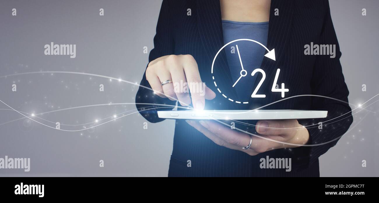 Business button 24 hours service. White tablet in businesswoman hand with digital hologram 24/7 all day all night icon on grey background. Full time s Stock Photo