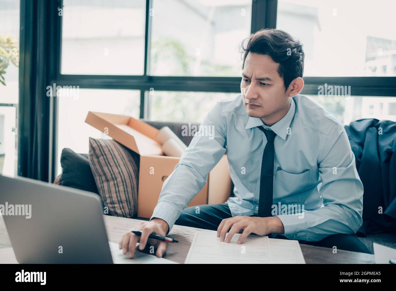 Young businessman working on laptop. Stock Photo