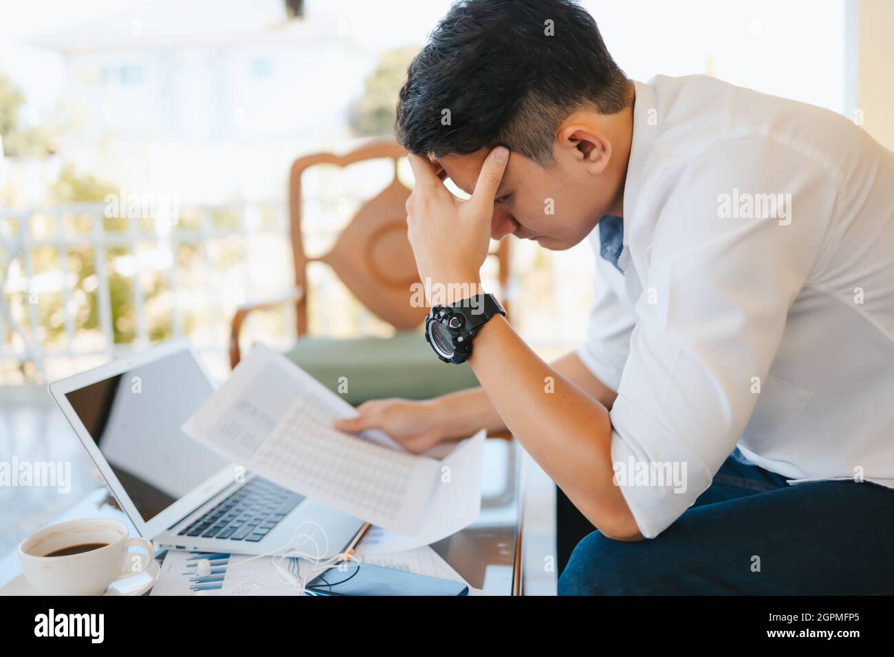 Tired businessman at workplace in office holding his headache or angry