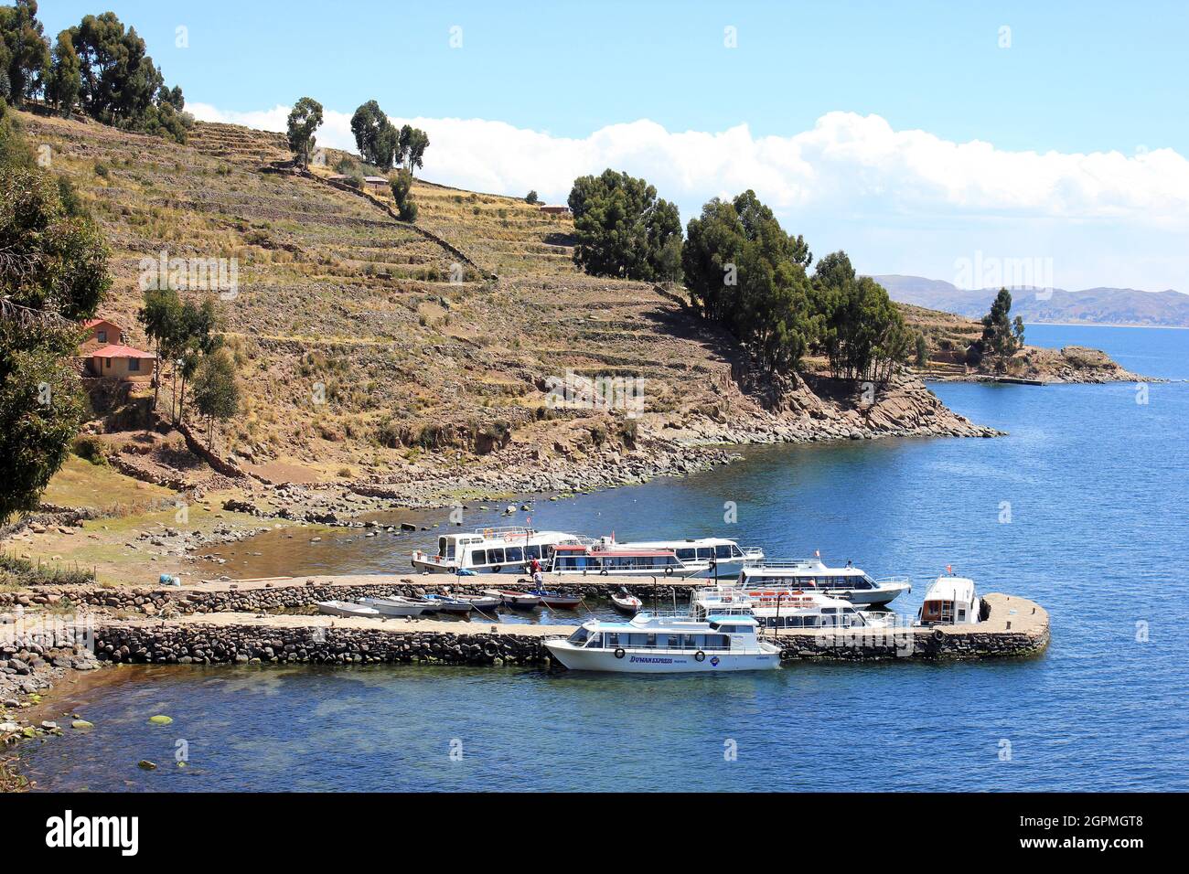 Cruise Boats Moored On Stone Jetty At Taquile Island, Peru Stock Photo