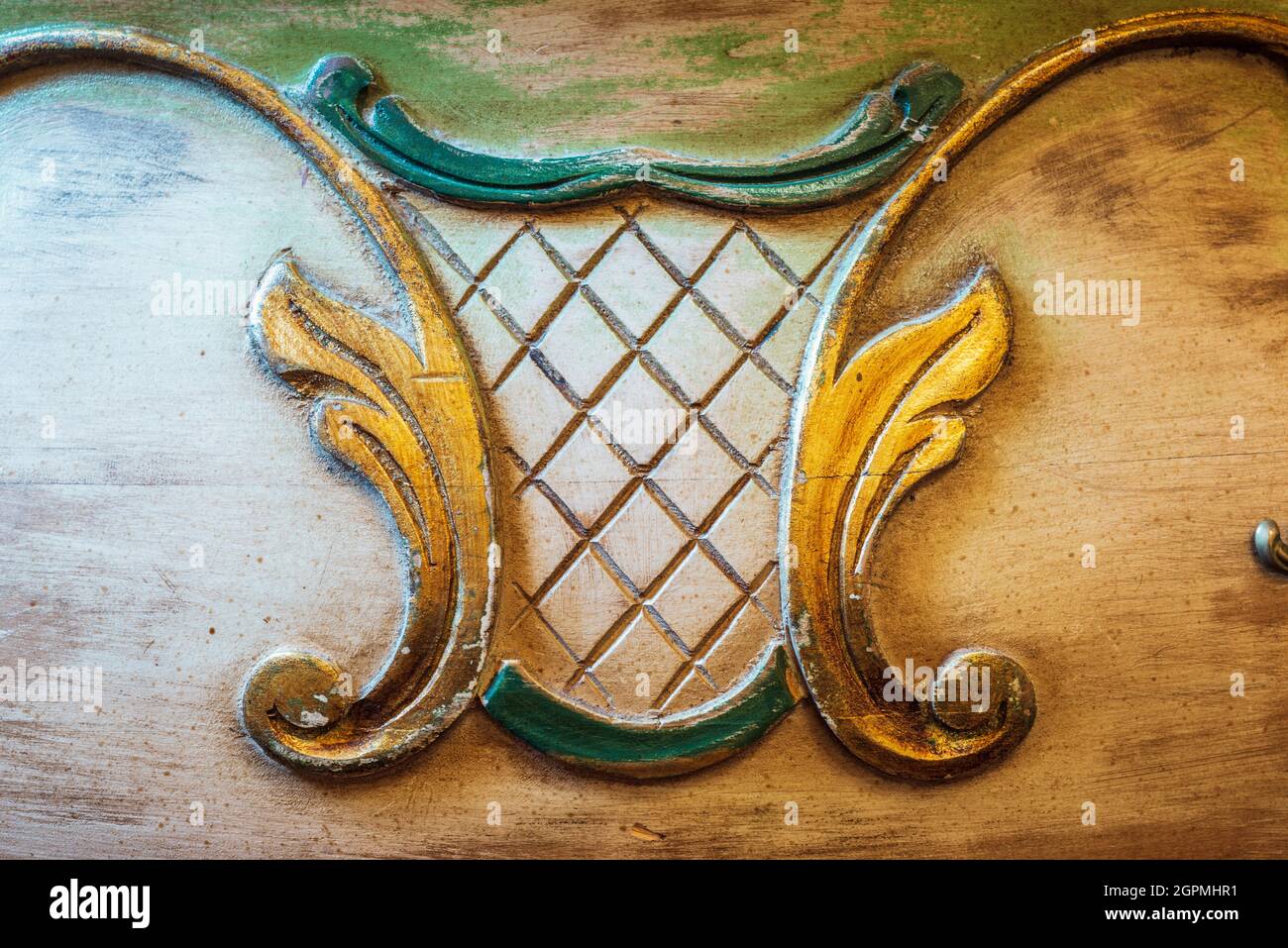 carved decorations on wooden surface of ancient Italian wardrobe Stock Photo