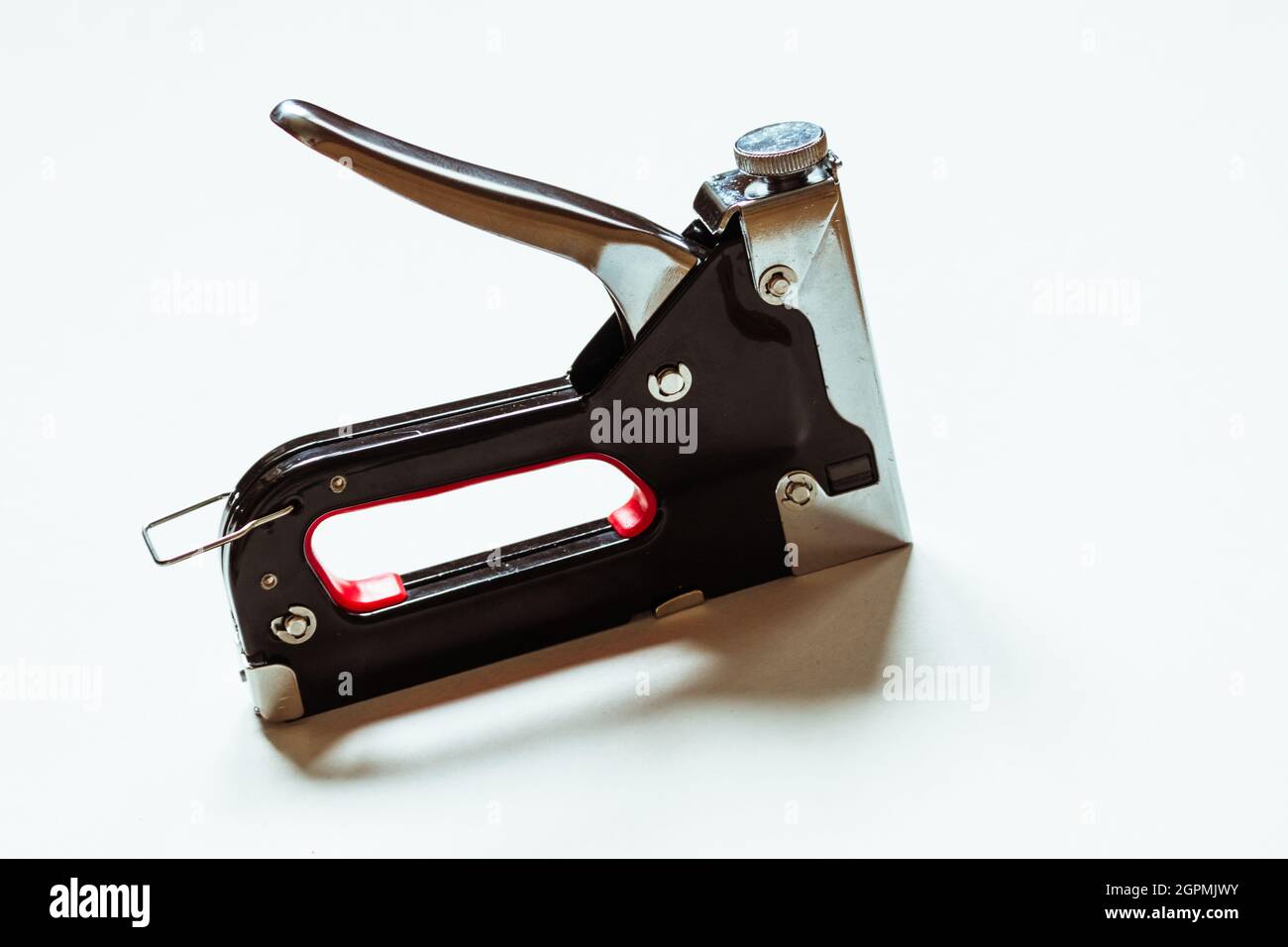 Furniture black construction stapler on a white background.  Stock Photo