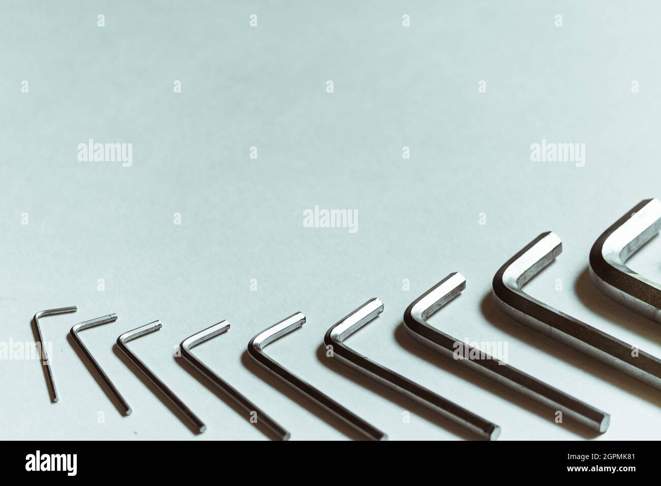A set of hex keys lies on a white background with plenty of space for