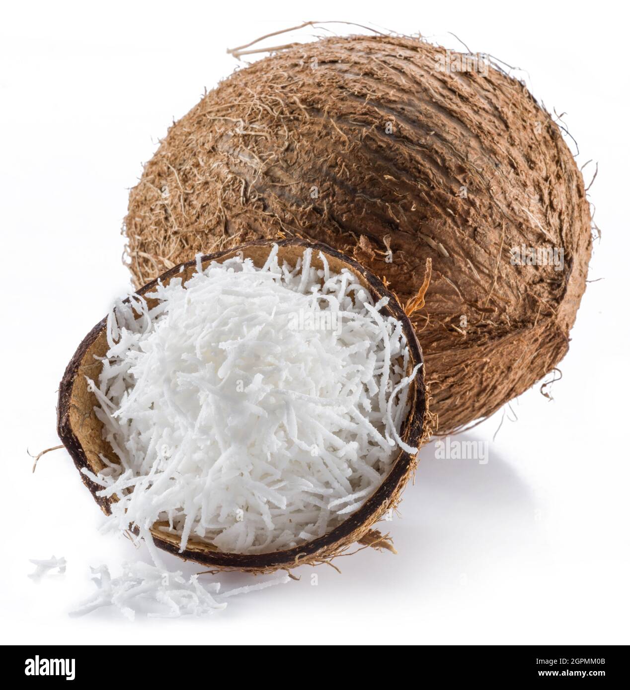 Coconut fruit and shredded coconut flakes isolated on white background