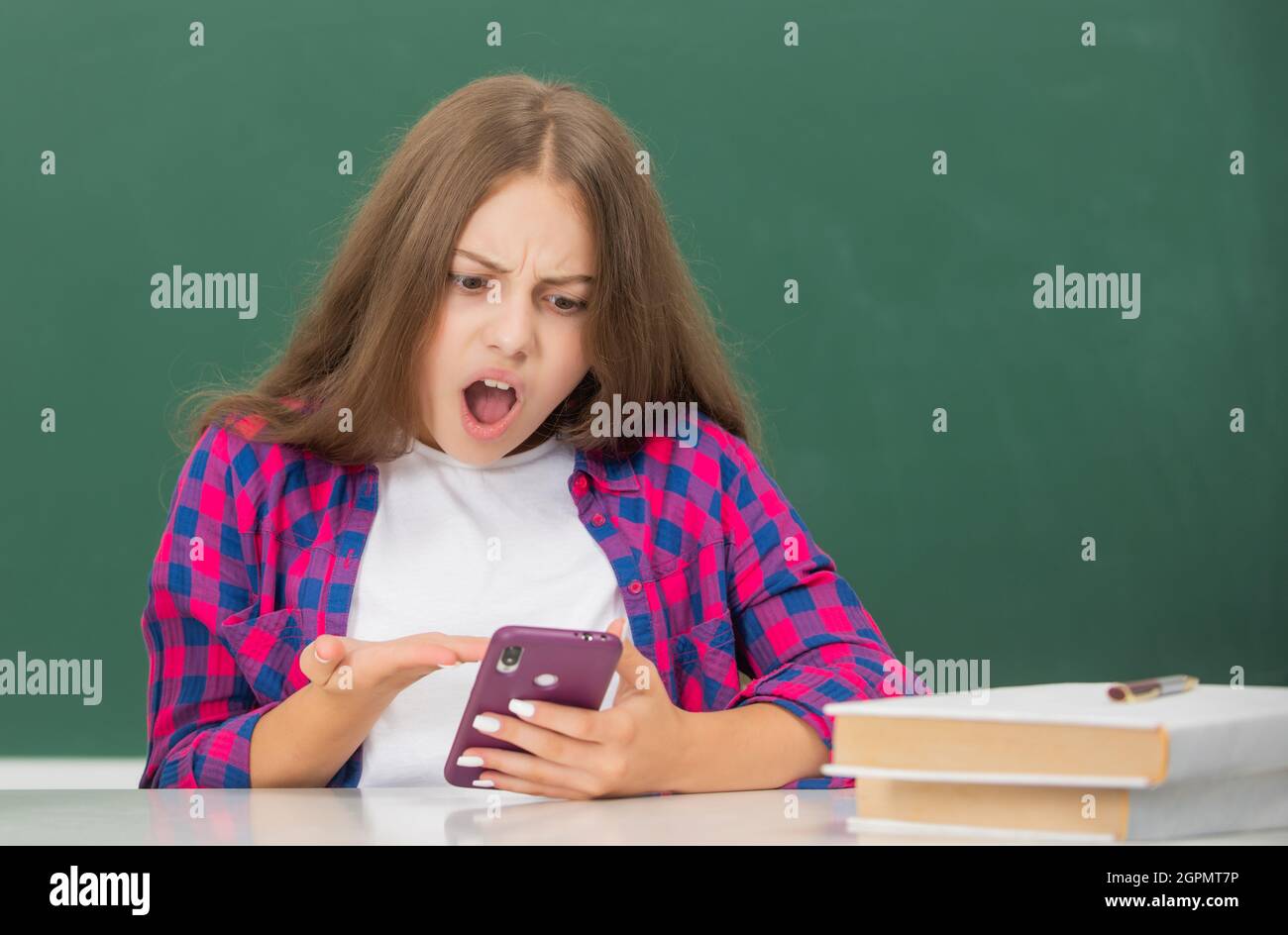 shocked child typing and texting. sms and instant messaging. Stock Photo