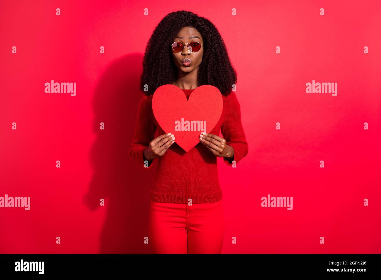 Photo of cute flirty dark skin lady wear casual sweater eyewear holding ...