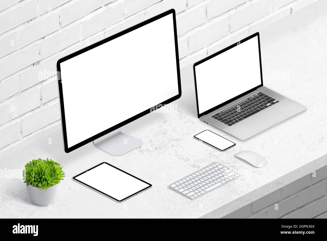 Devices on office desk for responsive web design promotion. Computer display, laptop, tablet and smart phone with isolated screen for mockup Stock Photo