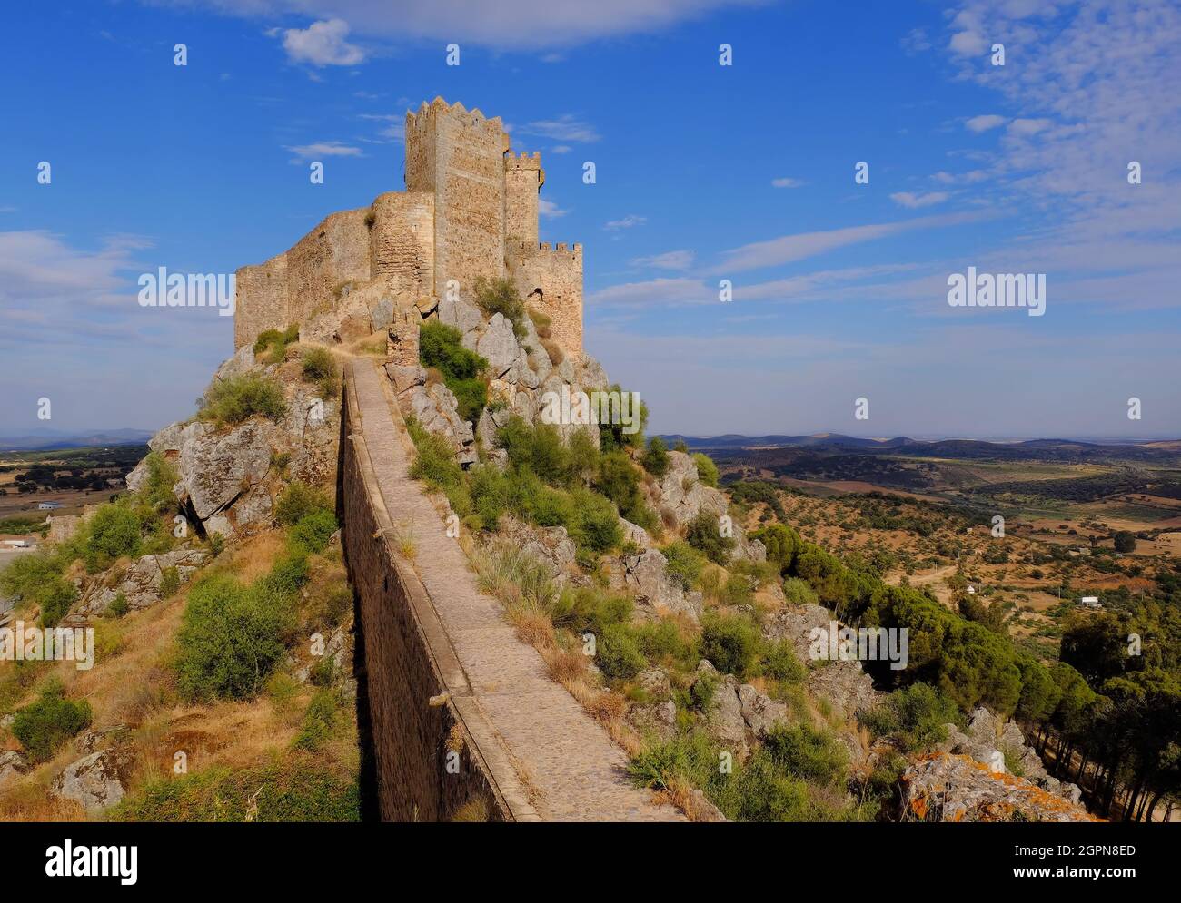 Spectacular angle of Alburquerque Castle and wall soon before sunset in Alburquerque, Badajoz, Spain Stock Photo