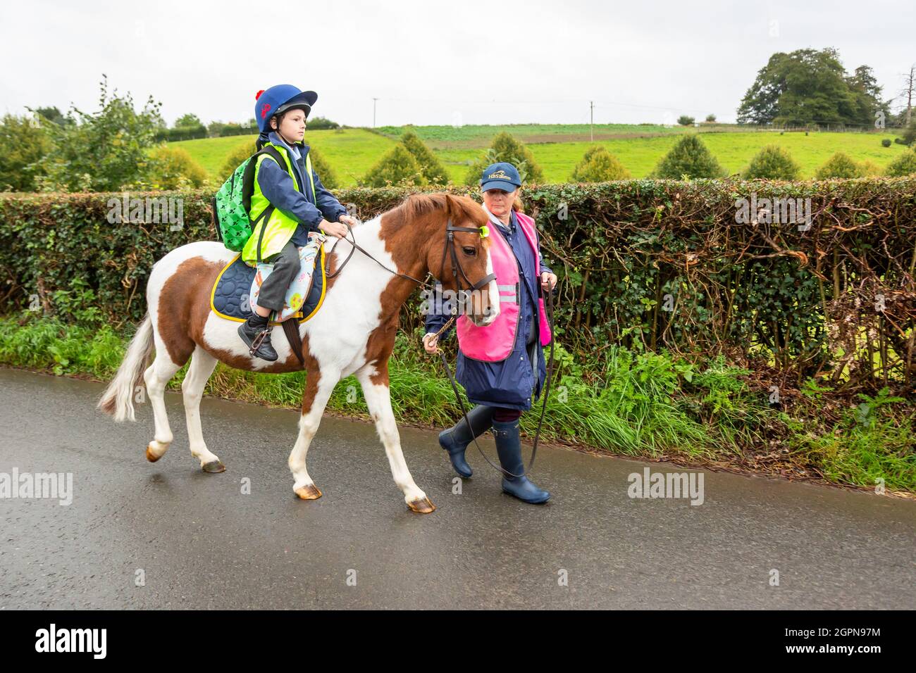 Upper Arley, Worcestershire, UK. 30th Sep, 2021. Grandmother Jane Mundie beats the fuel shortage crisis by using her pony 'Fern' on the school run. Her grandson Henley, 8, confidently rides the pony the two miles to Upper Arley C of E primary school in rural Worcestershire. 'I can't get diesel for my Land Rover at the moment but we don't need to worry too much when the children have our pony, Fern. And it's definitely a fun and green way to get to school,' says Jane. Credit: Peter Lopeman/Alamy Live News Stock Photo
