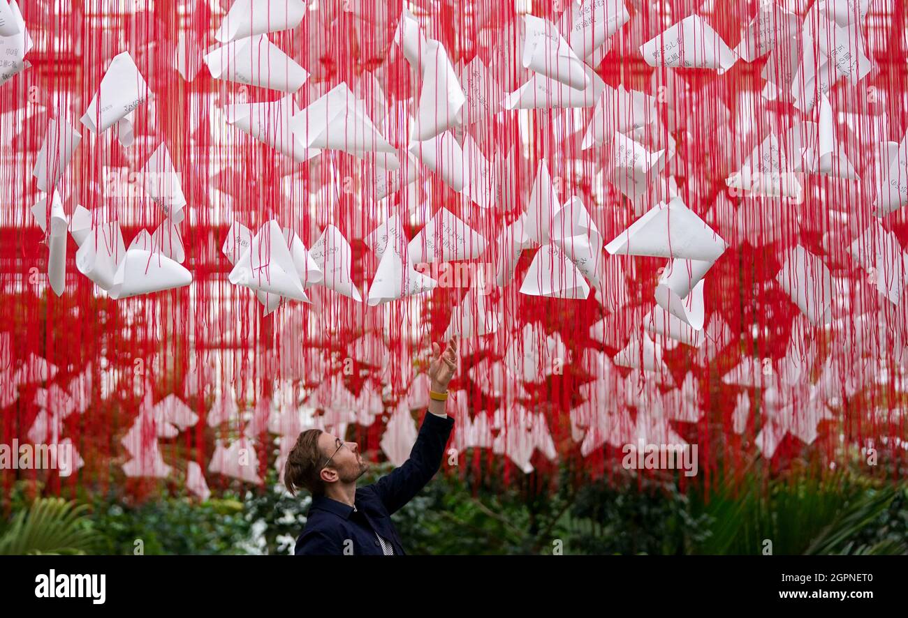 Paul Denton, Head of visitor programmes and exhibitions for Royal Botanic Gardens Kew, looks at the centrepiece called 'One Thousand Springs' created by Japanese artist Chiharu Shiota during a photocall for the Japan Festival, which is a celebration of the country's breath-taking plants, art and culture, at the Royal Botanic Gardens, Kew, London. Picture date: Thursday September 30, 2021. Stock Photo
