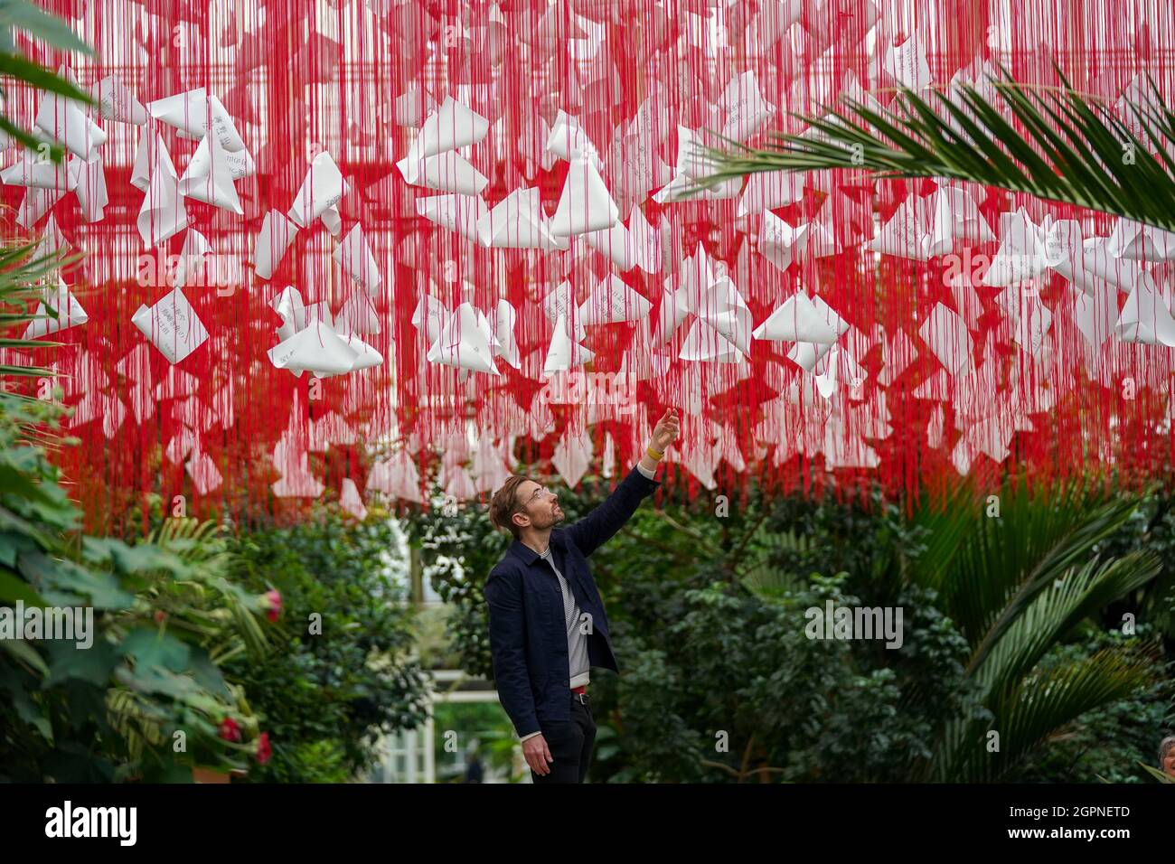 Paul Denton, Head of visitor programmes and exhibitions for Royal Botanic Gardens Kew, looks at the centrepiece called 'One Thousand Springs' created by Japanese artist Chiharu Shiota during a photocall for the Japan Festival, which is a celebration of the country's breath-taking plants, art and culture, at the Royal Botanic Gardens, Kew, London. Picture date: Thursday September 30, 2021. Stock Photo