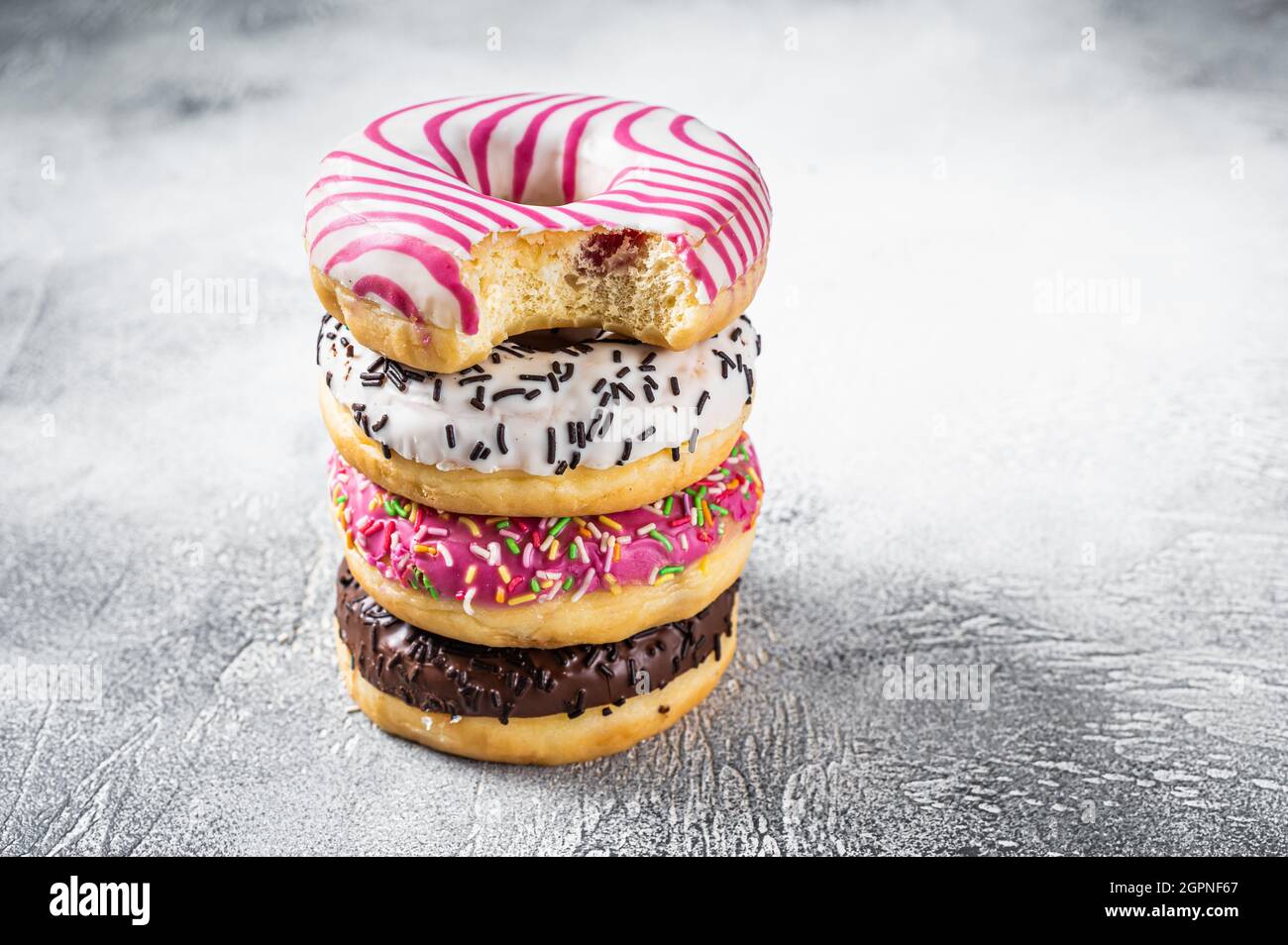 Stack of artisan donuts. White background. Top view. Copy space Stock Photo