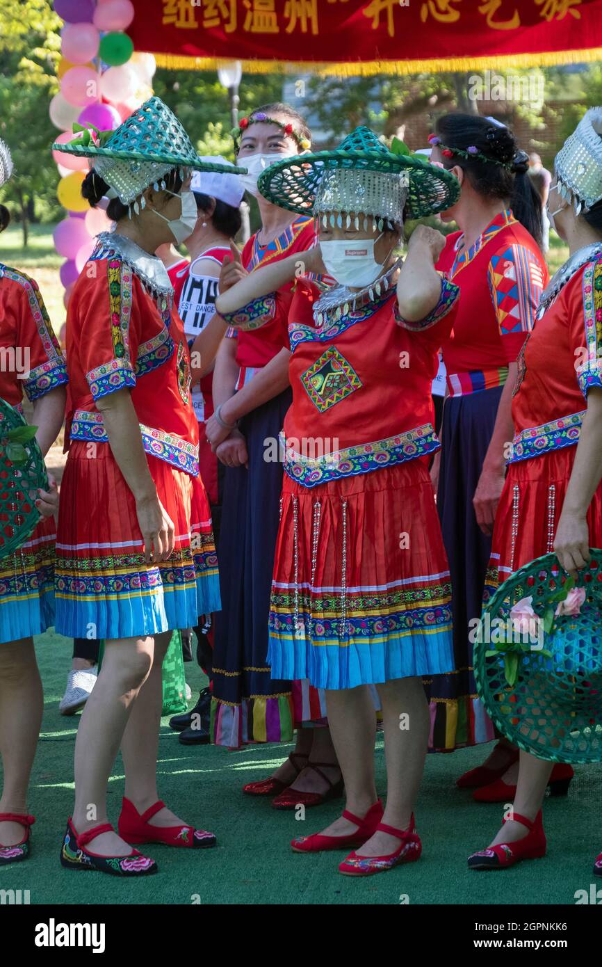 Women from Wenzhou, China in the Kai Xin Yizhu dance troupe prepare  for a 6th anniversary performance in a Kissena Park in Queens, New York. Stock Photo